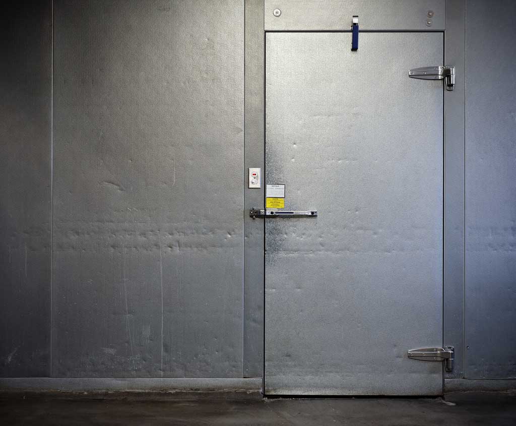 A closed door of a large walk-in freezer