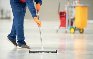 cleaning professional using squeegee mop to wash floor