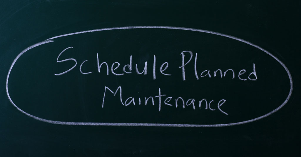 the words schedule planned maintenance written on a chalkboard
